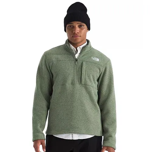 A person wearing a light green fleece pullover with a half-zip and a chest pocket, paired with a black beanie and a white collared shirt underneath.