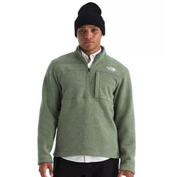 A person wearing a light green fleece pullover with a half-zip and a chest pocket, paired with a black beanie and a white collared shirt underneath.