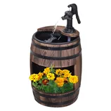 Wooden barrel with a water pump fountain on top, featuring a small flower bed with yellow marigolds in the bottom section.