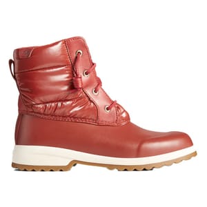 Sperry Maritime Snow Boots are red with a quilted, water-resistant upper, featuring laces for a secure fit, and a beige non-slip sole designed for snowy conditions.