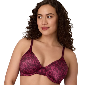 A woman is wearing a red bra with a floral pattern and adjustable straps. The bra features molded cups and an underwire design.