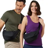 Two people are wearing black sling bags across their chests. One person is in a green shirt and beige pants; the other is in a purple tank top and blue leggings.