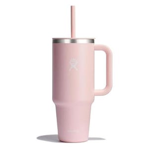 A pink 40oz Hydro Flask tumbler with a wide handle and a straw lid. Made of stainless steel with a double-wall vacuum insulation and a sleek, matte finish for keeping beverages hot or cold.