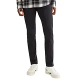 A person is wearing black jeans, white sneakers, and a black-and-white plaid shirt.