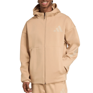 A beige full-zip hoodie featuring a minimalist design with a subtle logo on the chest and sleeve. Paired with matching sweatpants, the outfit offers a casual, coordinated look.