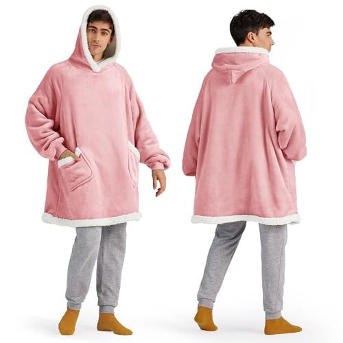 A pink oversized wearable blanket with a hood and large front pocket, shown from the front and back, worn over gray pants and orange socks.