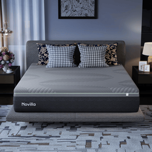 Novilla mattress on a bed with patterned pillows, surrounded by decor including a nightstand with a lamp and a vase of flowers.