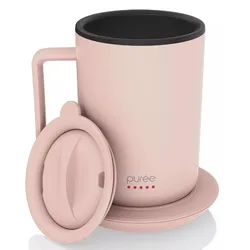 A pink mug with a handle and lid, labeled \“purée\“ with red dots, featuring a black interior.