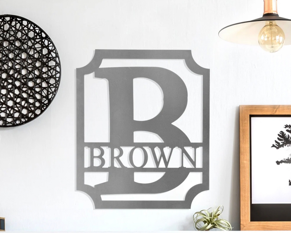 Wall decal with the letter \“B\“ inside a shield silhouette, featuring the word \“BROWN\“ below, displayed on a home wall.