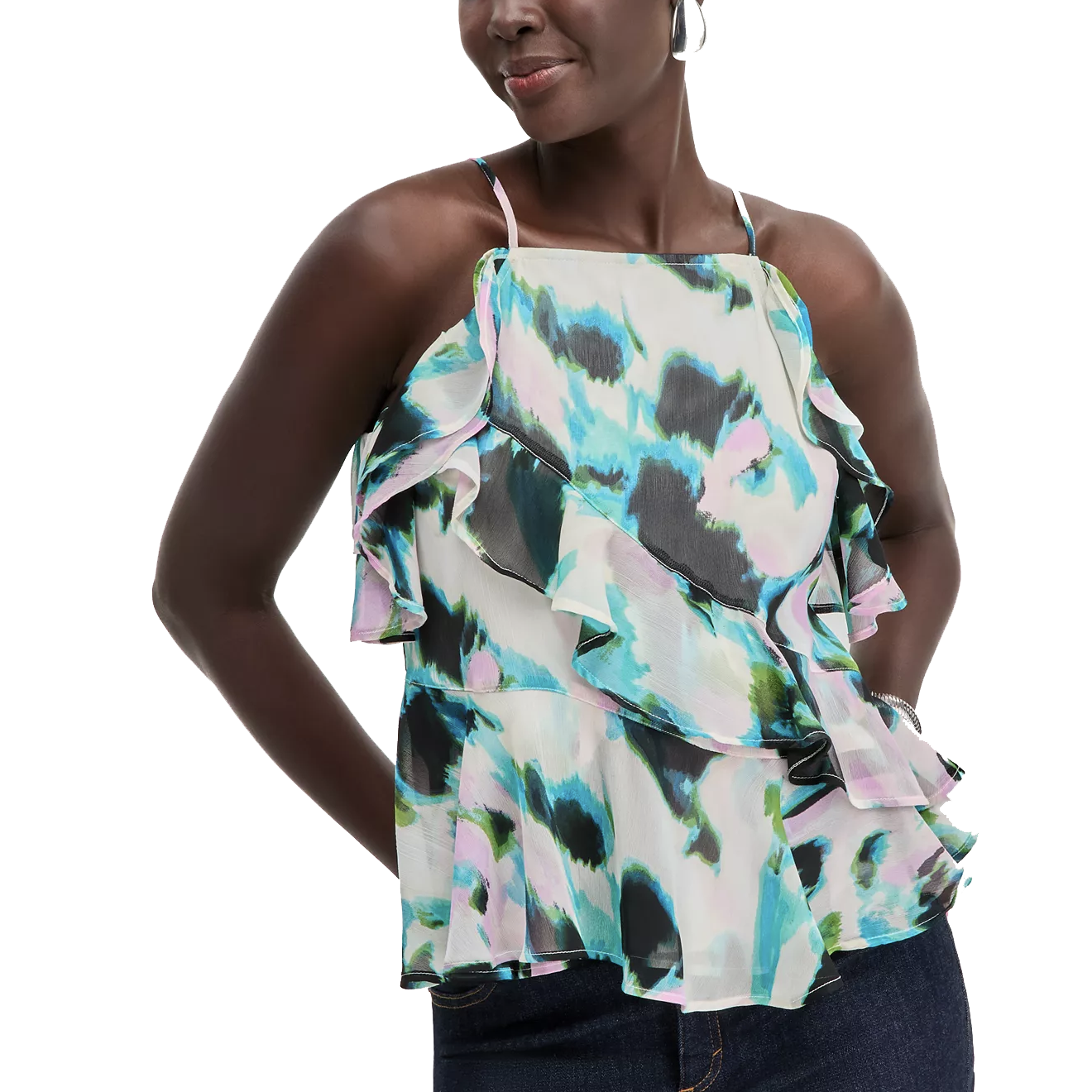 A woman is wearing a colorful, abstract-patterned sleeveless top with ruffled layers and thin straps. The top features shades of blue, green, and pink.