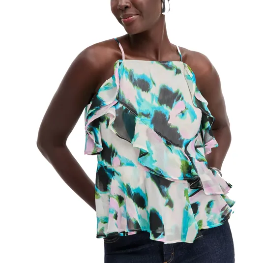 A woman is wearing a colorful, abstract-patterned sleeveless top with ruffled layers and thin straps. The top features shades of blue, green, and pink.