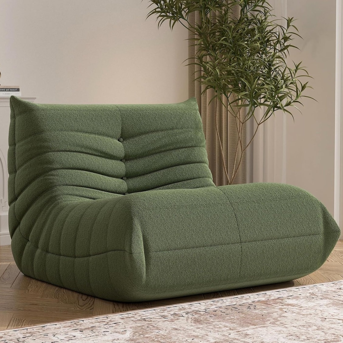 Green, plush, textured bean bag-style chair with a tufted design, offering a cozy and comfortable seating option. It's positioned on a wooden floor with a plant in the background.