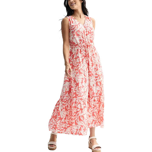 A sleeveless, ankle-length pink and white floral dress with a V-neck and tiered skirt, paired with platform sandals.