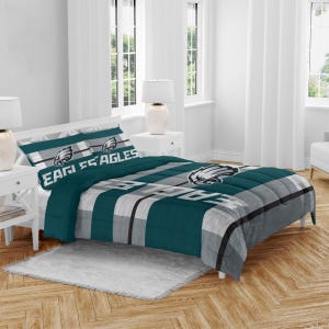 NFL Bed-in-a-Bag Comforter Sets feature team-themed designs, with the Eagles logo and colors. The set includes a comforter and matching pillow shams, ideal for fans looking to add a sporty touch to their bedroom decor.