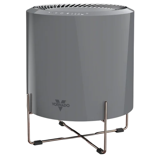 A Vornado air purifier with a sleek cylindrical design and a metal stand, featuring touch controls on the top.