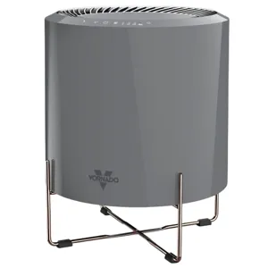 A Vornado air purifier with a sleek cylindrical design and a metal stand, featuring touch controls on the top.