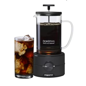 Dorothy Rapid Cold Brewer is shown next to a glass of iced coffee with cream.