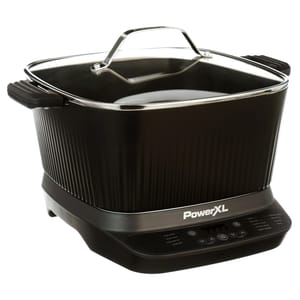 PowerXL electric cooker with a black body, ribbed sides, handles, and a glass lid. Features a digital control panel for various cooking functions.
