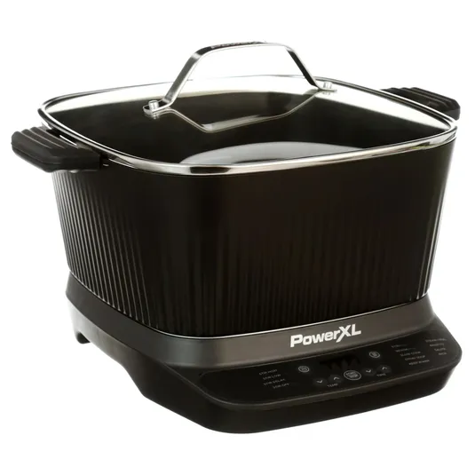 PowerXL electric cooker with a black body, ribbed sides, handles, and a glass lid. Features a digital control panel for various cooking functions.