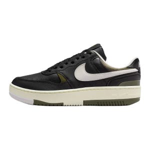 A low-top sneaker with a black leather upper, white swoosh, and cream midsole. It features a perforated toe box and padded collar.