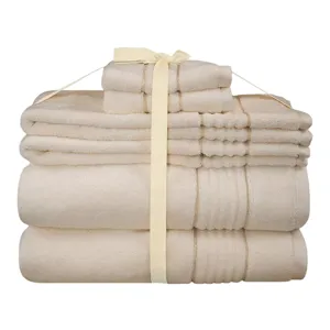 A beige towel set includes bath towels, hand towels, and washcloths, neatly tied together with a ribbon.
