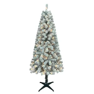 A flocked artificial Christmas tree with warm white lights and a black stand.