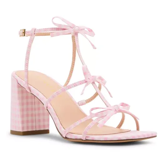 Pink gingham strappy sandal featuring a block heel, ankle strap with buckle closure, and decorative bows.