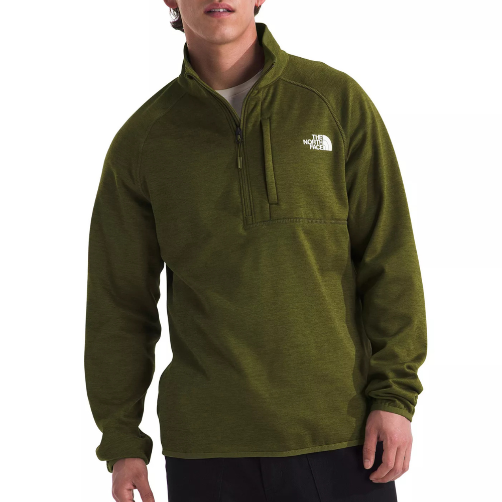 A man wears an olive green North Face half-zip pullover with a chest pocket and logo on the front.