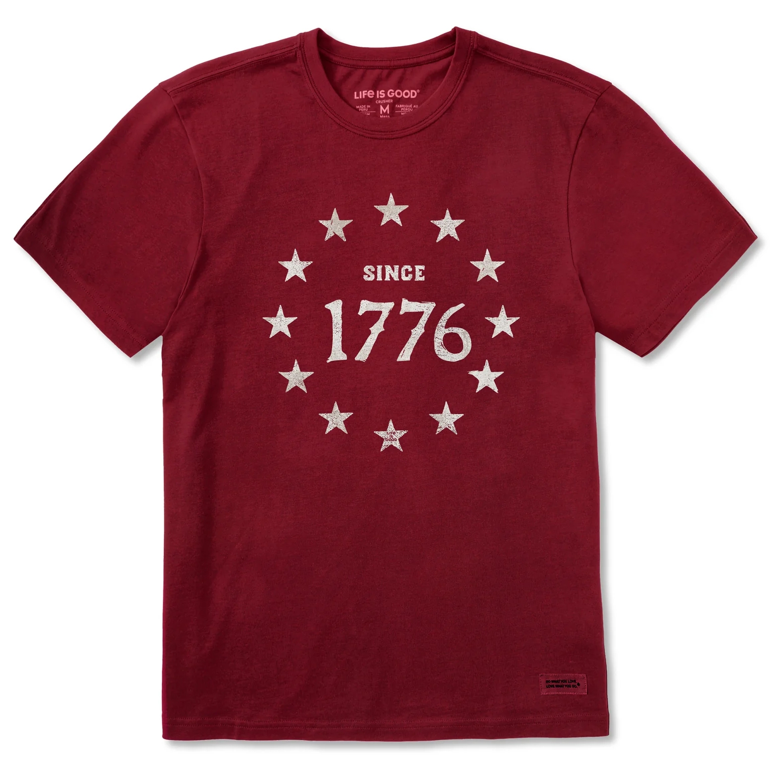 A maroon T-shirt with a graphic depicting \“Since 1776\“ surrounded by thirteen white stars.