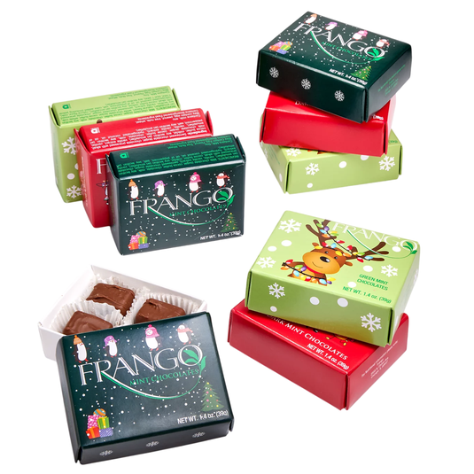 Assorted Frango mint chocolates in holiday-themed boxes featuring penguins and a reindeer, each weighing 1.4 oz (39g). Boxes are stacked in various colors: dark green, red, and light green.