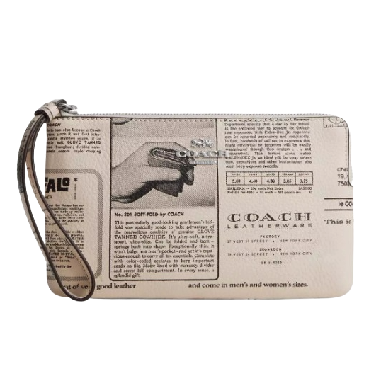 A Coach wristlet features a vintage newspaper print design with a prominent Coach Leatherware logo and a strap for easy carrying.