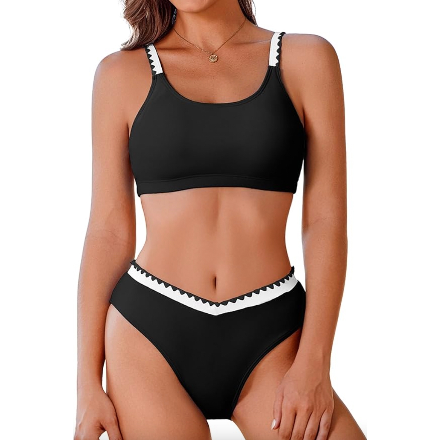 A sporty black bikini featuring a high-neck top with white and black strap detailing and matching high-waisted bottoms with a white zigzag trim.