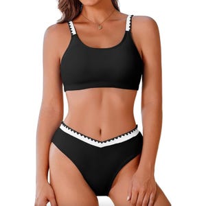 A sporty black bikini featuring a high-neck top with white and black strap detailing and matching high-waisted bottoms with a white zigzag trim.