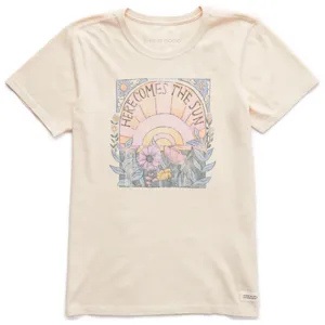 Cream-colored T-shirt featuring a \“Here Comes the Sun\“ graphic with a sunburst, flowers, and foliage design.