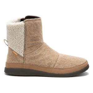 Chaco Revel Boots are tan ankle-length boots with a cozy fleece lining and a textured brown rubber outsole. They feature a pull tab at the back and a subtle brand tag on the side.