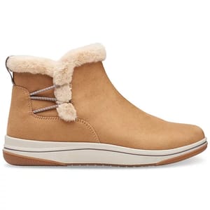 Tan ankle boots with fluffy fur lining and decorative crisscross lacing detail at the back, featuring a flat rubber outsole.