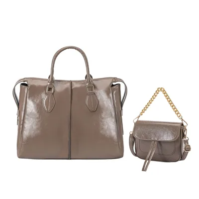 A large brown leather handbag with short handles is paired with a smaller leather crossbody bag featuring a gold chain strap and buckle detail.