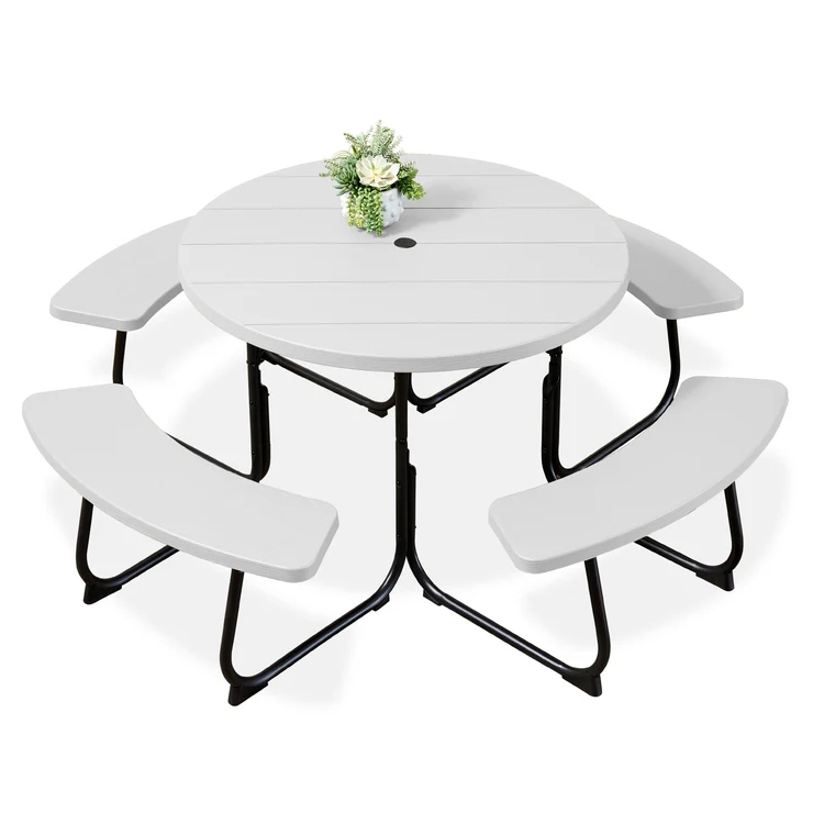 Round folding picnic table set with a white tabletop, integrated with three curved benches and a central umbrella hole. Decorated with a small flower arrangement.