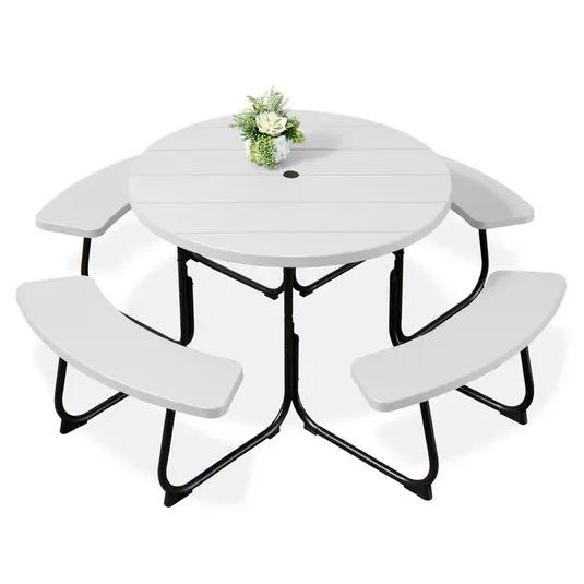 Round folding picnic table set with a white tabletop, integrated with three curved benches and a central umbrella hole. Decorated with a small flower arrangement.