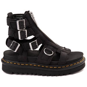 Black gladiator-style sandal with a zip closure, buckle straps, and a thick platform sole featuring yellow stitching.