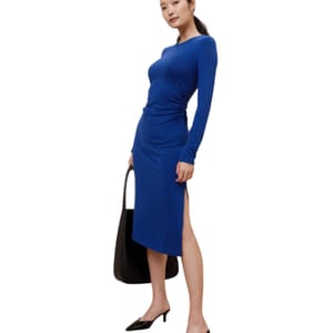 Blue long-sleeve midi dress with a side slit and a bodycon fit. It features a gathered detail at the waist, paired with black pointed-toe shoes and a large black tote bag.