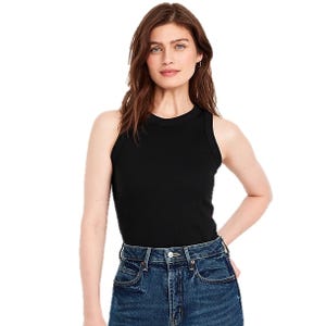 A woman wearing a black sleeveless top paired with high-waisted blue jeans.