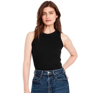A woman wearing a black sleeveless top paired with high-waisted blue jeans.