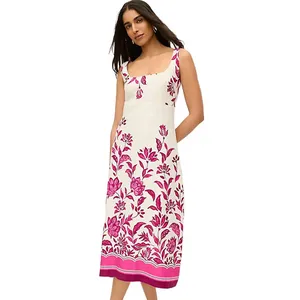 Sleeveless white dress with a fitted bodice and pink floral patterns extending to the hem, ending at a midi length.