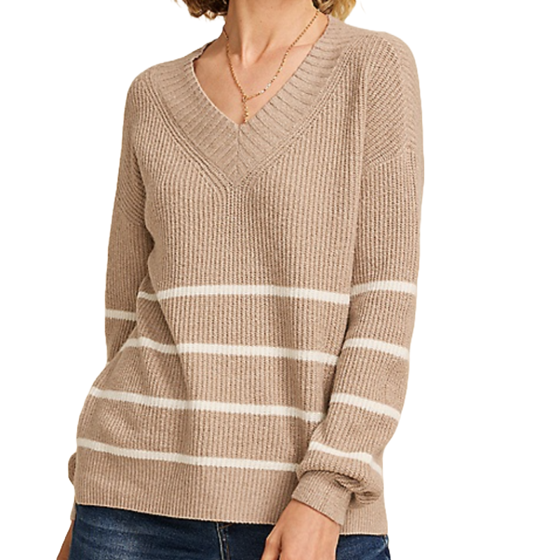 Beige V-neck sweater with white horizontal stripes, paired with dark jeans and a necklace.