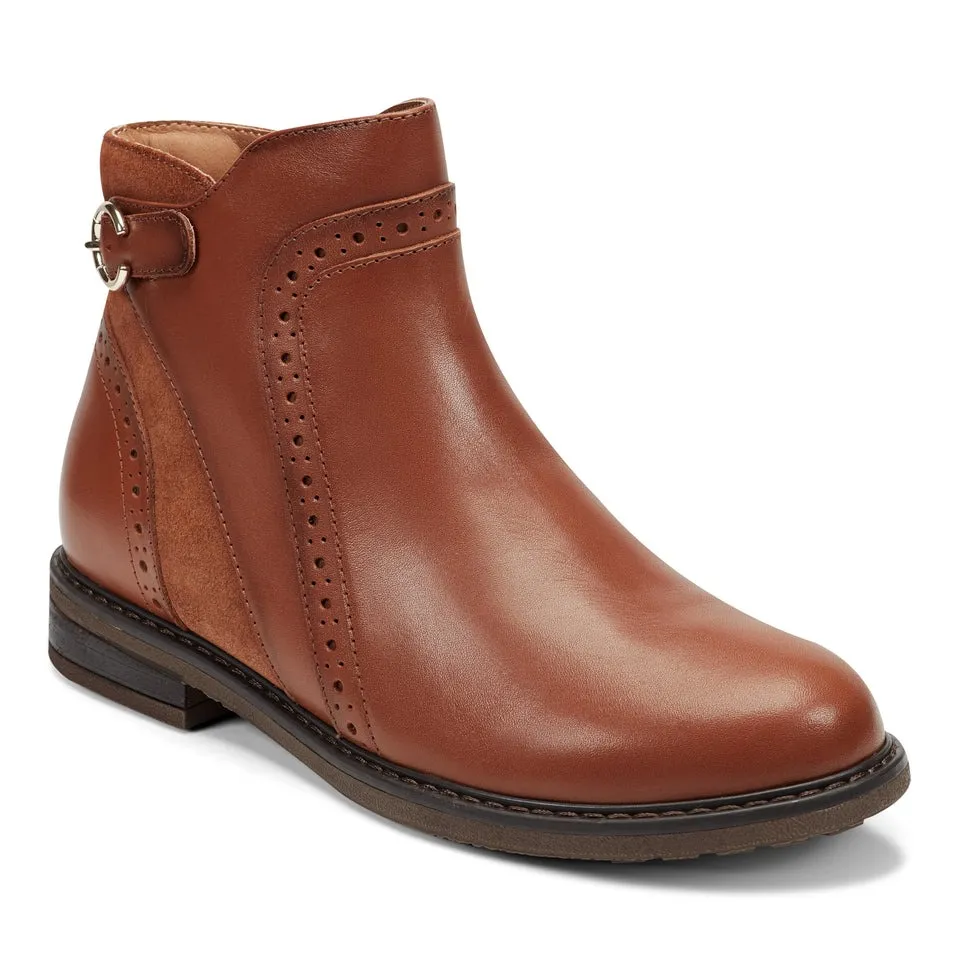 Brown leather ankle boot with decorative perforations and a side buckle detail, featuring a low heel and stitched sole.