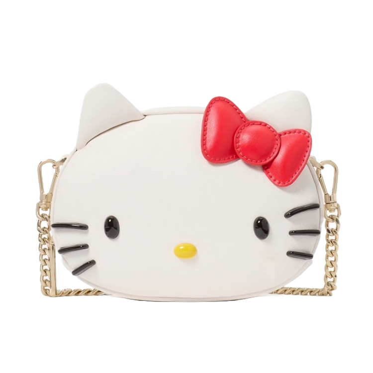 Hello Kitty X Ksny 3D Mini Crossbody features a white bag shaped like Hello Kitty's face with black whiskers, a red bow, and a yellow nose, adorned with a gold chain strap.