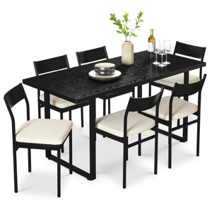 A black dining set featuring a rectangular table and six chairs with cream cushioned seats. The table is decorated with a vase of greenery, a bottle of wine, wine glasses, and stacked plates.
