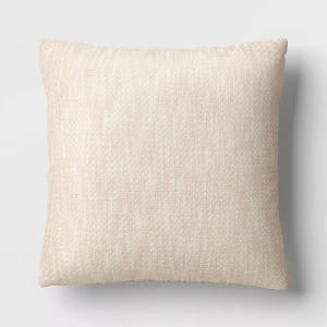 A beige textured throw pillow.