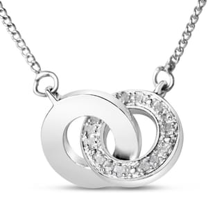 A necklace featuring two interlocking circles, one polished and the other adorned with small diamonds totaling 1/4 carat, crafted in a silver or white gold finish.